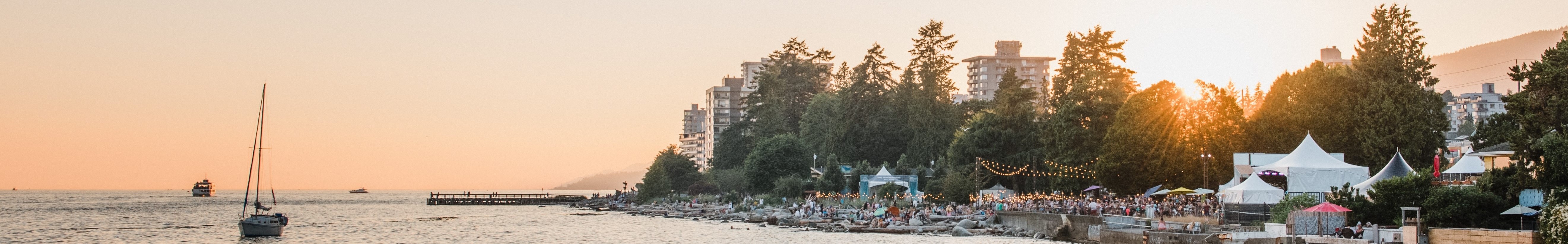 Scenic view of boats, trees, and a sunset over the water at West Vancouver waterfront.